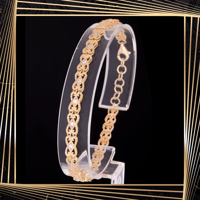 B398 Złota bransoletka. Ażurowe elementy z cyrkoniami. 585