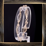 B409 Złota bransoletka. Dwukolorowe elementy z drogą grecką. 585