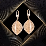 K1704 Złote kolczyki. Przestrzenne baryłki  z kwiecistym ażurem. Duże. 585